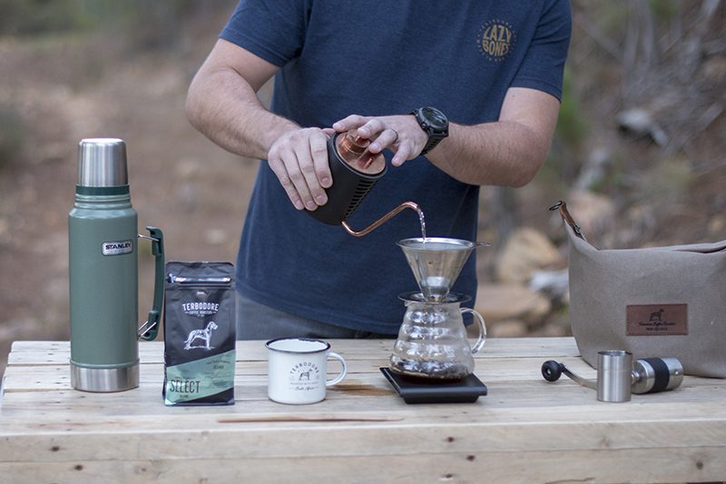 Man pouring water into a coffee brew - outdoors - Terbodore Coffee