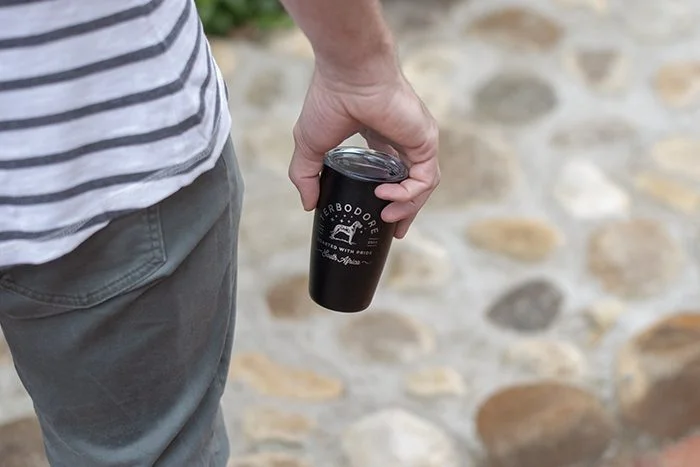 Terbodore MiiR coffee tumbler reusable eco friendly | TERBODORE Coffee Roasters Man holding Terbodore Miir coffee tumblere resuable eco-friendly