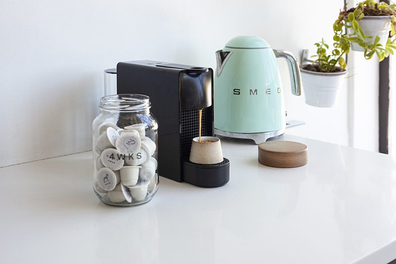 1_4WKS + Nespresso Machine_Pour | TERBODORE Coffee Roasters Nespresso machine, SMEG kettle and Terbodore 4WKS capsules on a kitchen counter